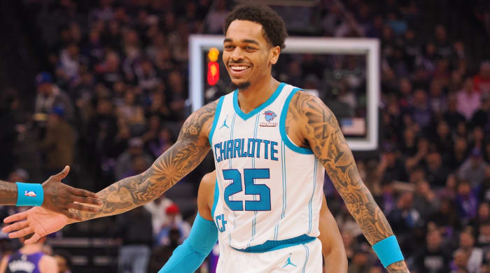 Charlotte Hornets forward P.J. Washington high fives teammates after making a basket against the Sacramento Kings during the first quarter at Golden 1 Center in Sacramento on Jan. 2, 2024.